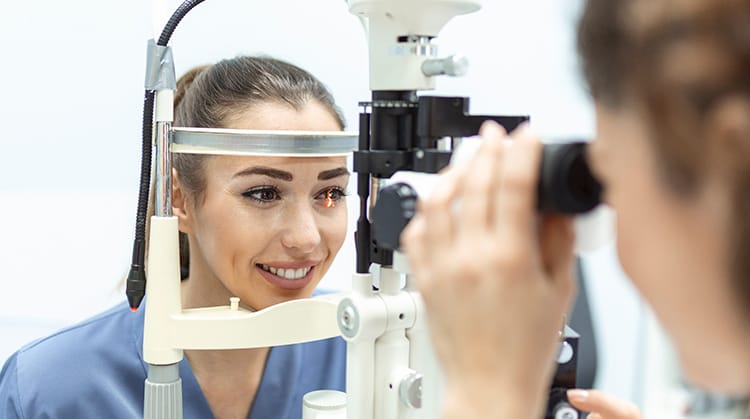 Patient getting her eye checked by ophthalmologist