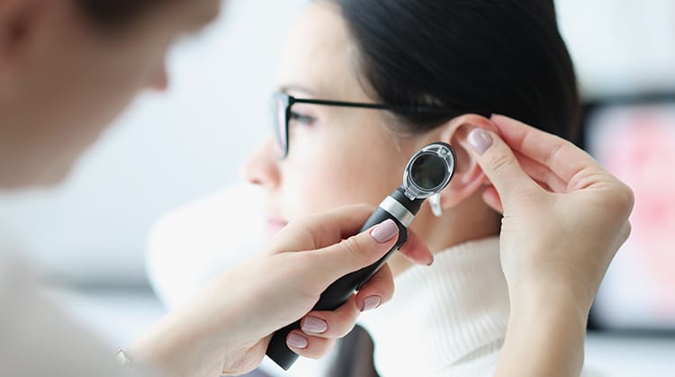 ENT Doctor examining the patient's ear