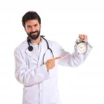 Doctor holding a clock over white background